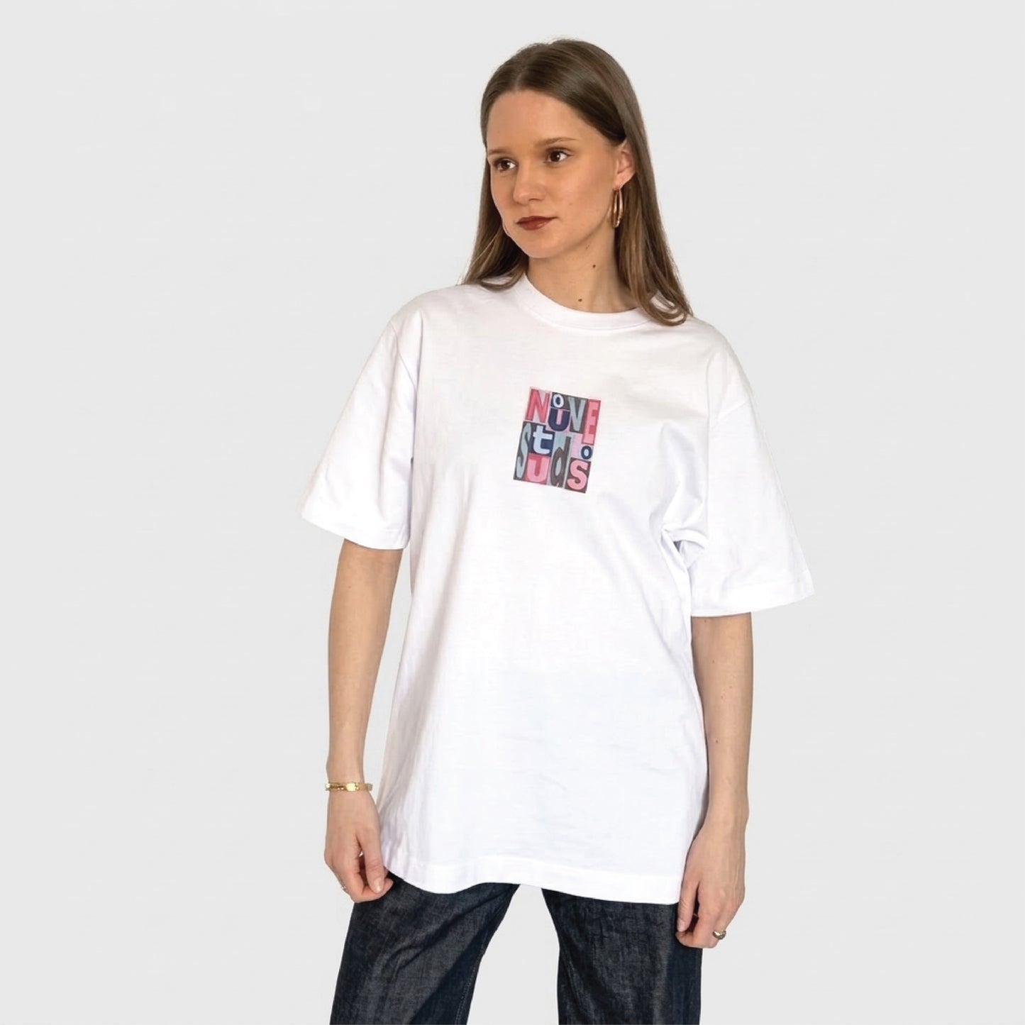 Model draagt wit Nouve Studios T-shirt met kleurrijke print op de borst